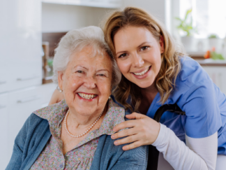 A picture of a smiling carer with a smiling elderly service user