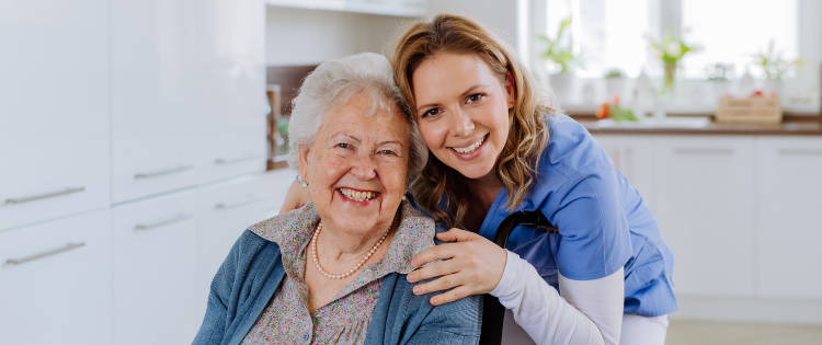 A picture of a smiling carer with a smiling elderly service user