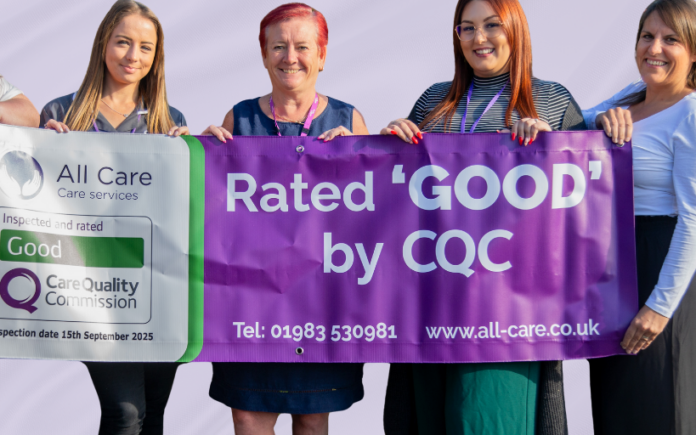 care staff who provide and oversee home care in the isle of wight standing together holding a CQC rated 'good' banner across five staff members who are smiling