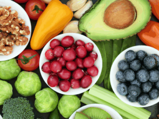A table with a selection of colourful fruit and vegetables.